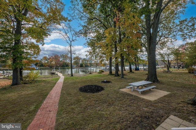 view of yard with a boat dock and a water view