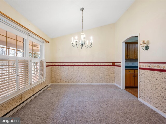 unfurnished dining area featuring a chandelier, carpet, baseboard heating, and lofted ceiling