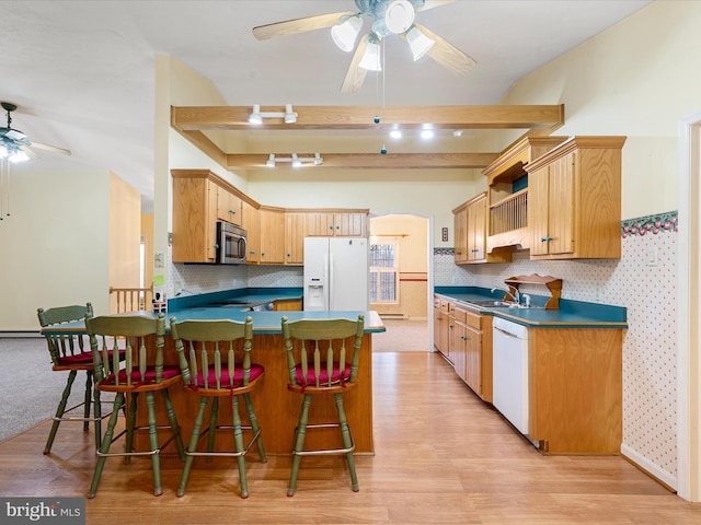 kitchen featuring light hardwood / wood-style floors, white appliances, kitchen peninsula, and light brown cabinets