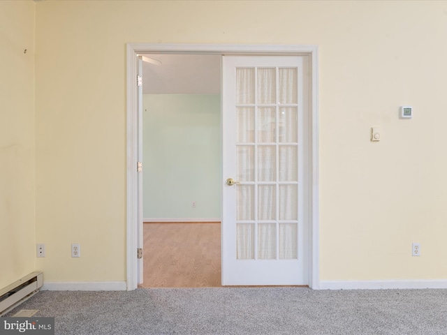 carpeted empty room with baseboard heating