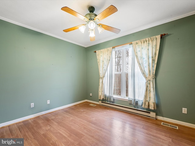 spare room featuring a baseboard radiator, hardwood / wood-style flooring, crown molding, and ceiling fan