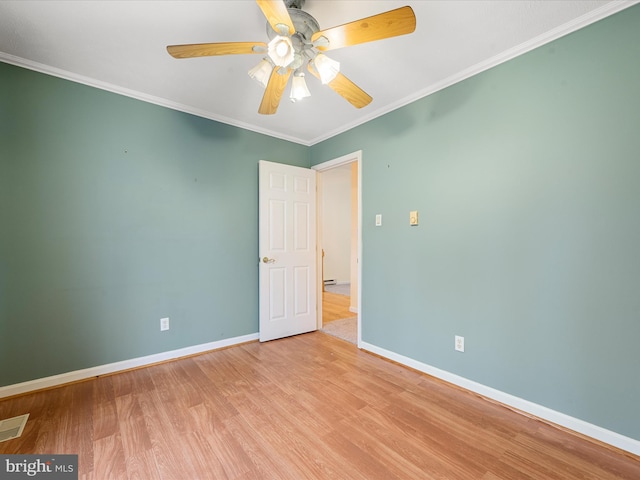 spare room with crown molding, ceiling fan, and light wood-type flooring