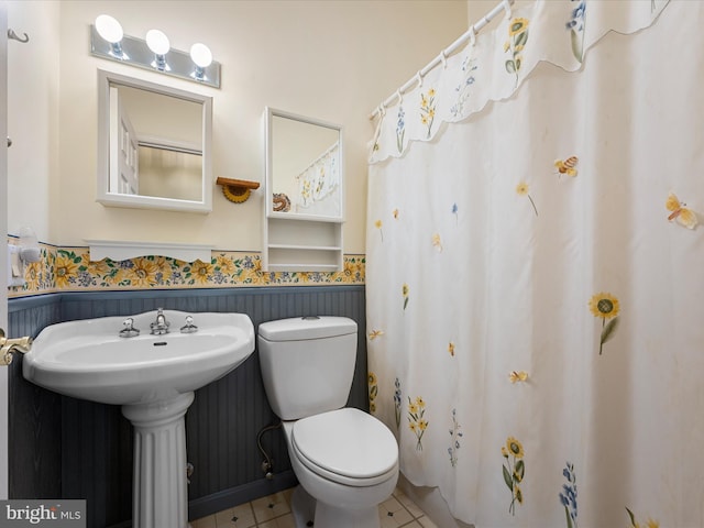 bathroom with tile patterned floors, toilet, and sink