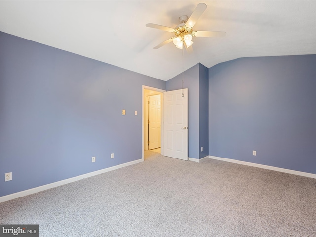 unfurnished bedroom featuring carpet floors, vaulted ceiling, and ceiling fan