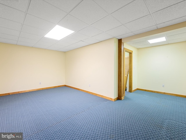 basement with a drop ceiling and carpet floors