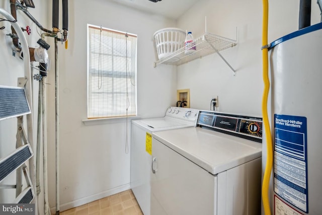 clothes washing area with gas water heater and washing machine and clothes dryer