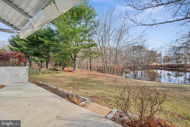 view of yard with a patio and a water view