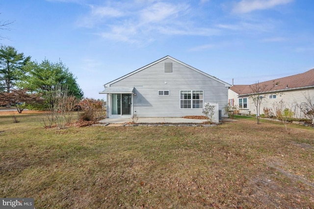 rear view of property with a lawn