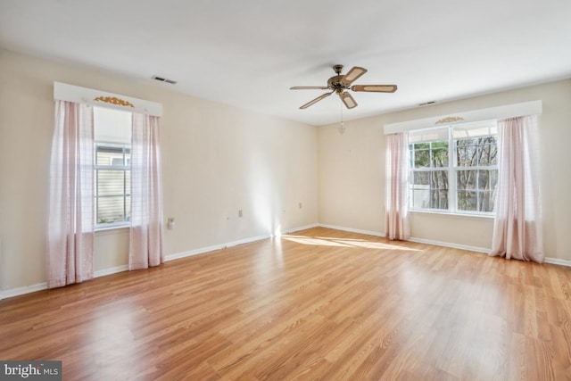 spare room with ceiling fan and light wood-type flooring