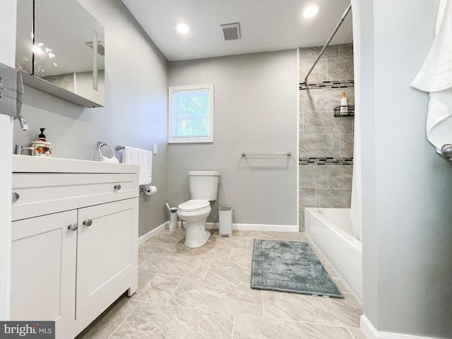 full bathroom featuring toilet, vanity, and tiled shower / bath