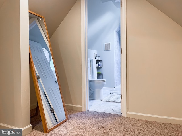 hall with lofted ceiling and carpet