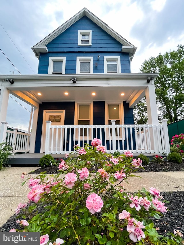 rear view of property with a porch