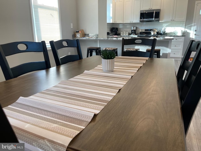 dining room with light hardwood / wood-style flooring