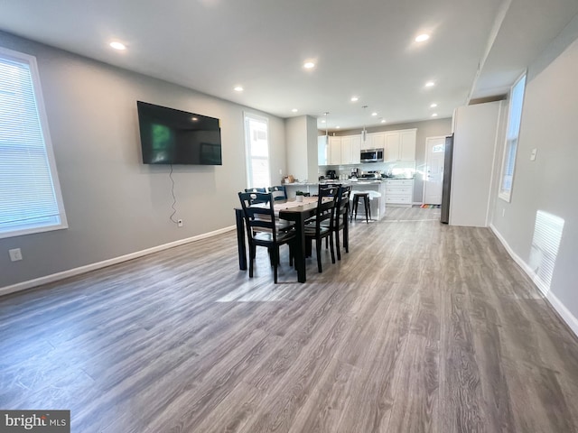 dining area with hardwood / wood-style flooring