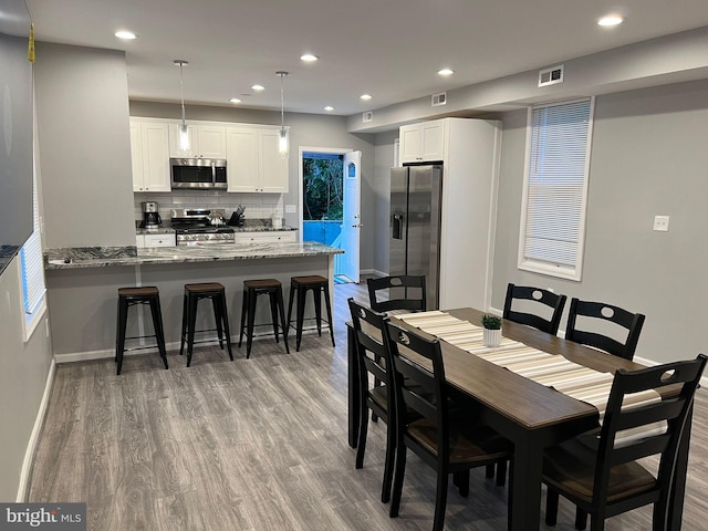 dining space featuring hardwood / wood-style flooring