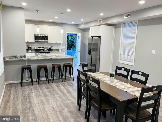 dining area with light hardwood / wood-style floors