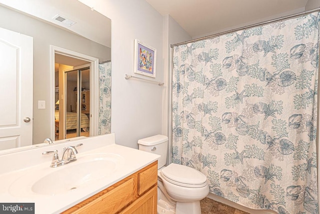 bathroom with tile patterned floors, vanity, toilet, and a shower with curtain