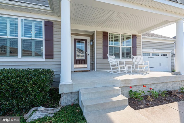 view of exterior entry featuring covered porch