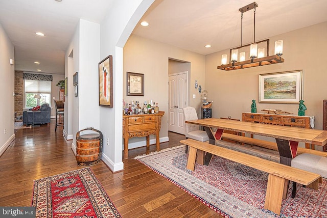 dining room featuring dark hardwood / wood-style floors and an inviting chandelier