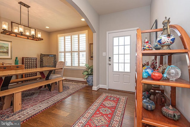 foyer with a chandelier and dark hardwood / wood-style flooring