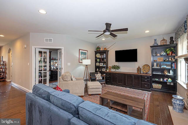 living room with dark hardwood / wood-style floors and ceiling fan