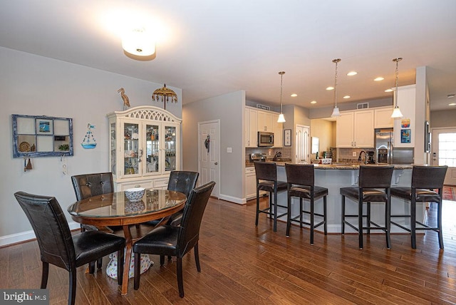 dining space featuring dark hardwood / wood-style floors