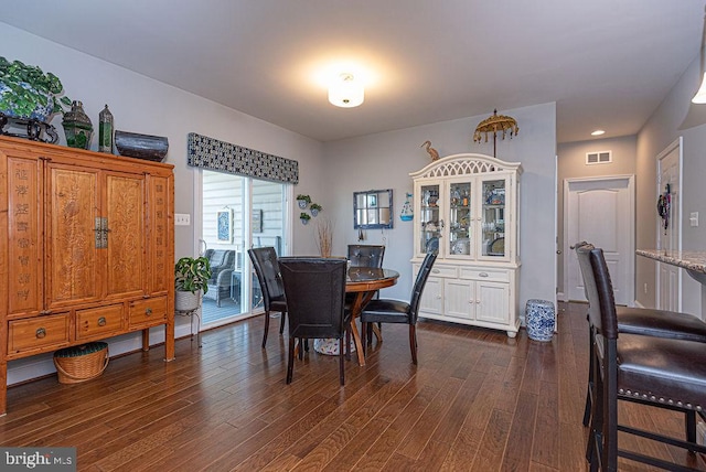 dining room with dark hardwood / wood-style flooring