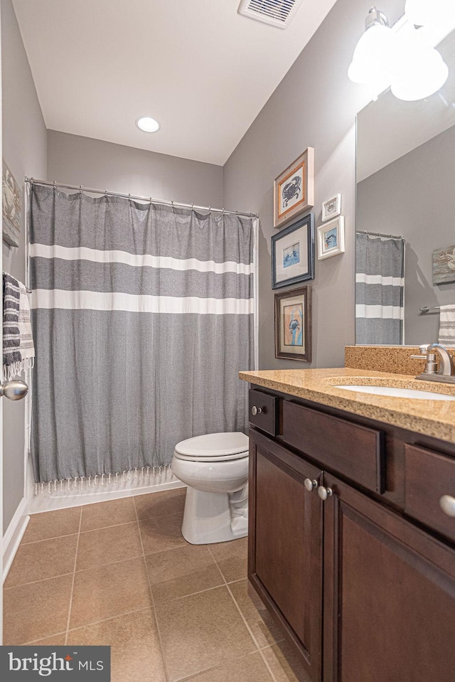 bathroom featuring toilet, vanity, and tile patterned floors