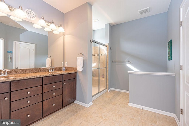 bathroom with tile patterned flooring, vanity, and a shower with shower door