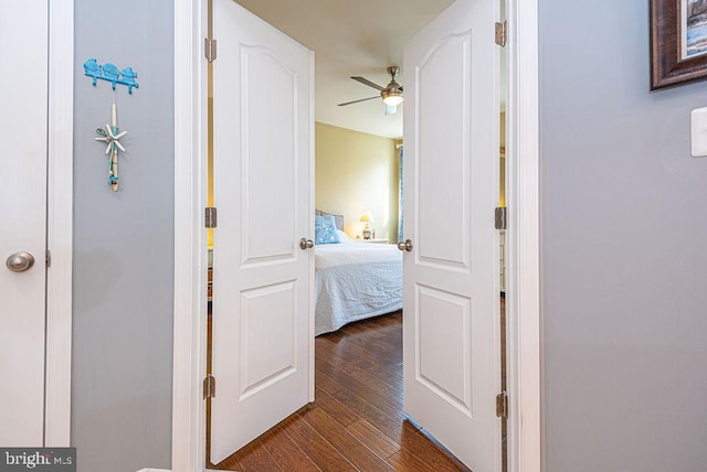 corridor with hardwood / wood-style floors