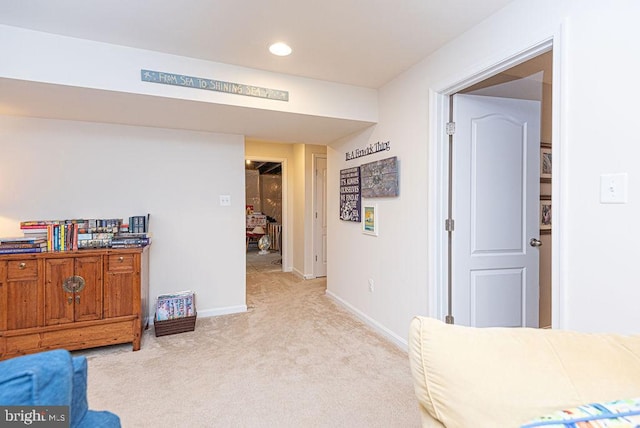 sitting room featuring light colored carpet