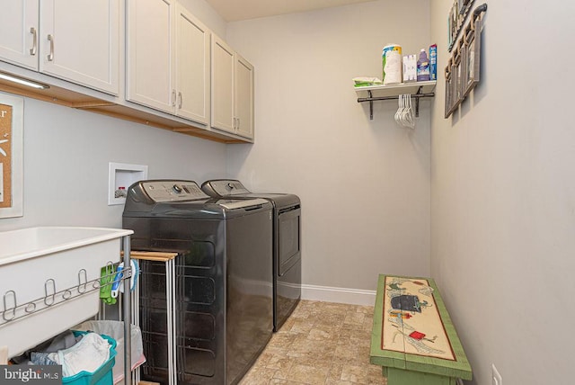 laundry area with cabinets and washing machine and dryer