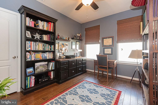 home office with ceiling fan and dark hardwood / wood-style floors