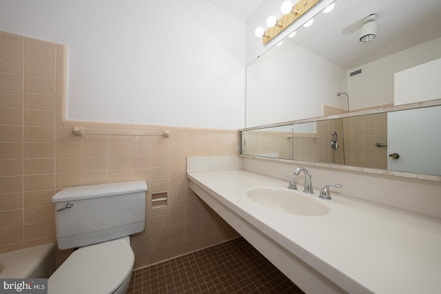 full bathroom with a sink, toilet, tile patterned floors, a shower, and wainscoting