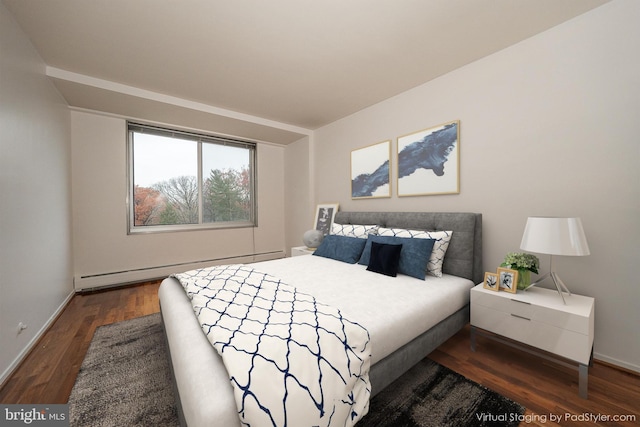bedroom featuring wood finished floors, a baseboard radiator, and baseboards