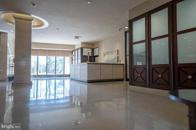 welcome area featuring ornate columns and recessed lighting