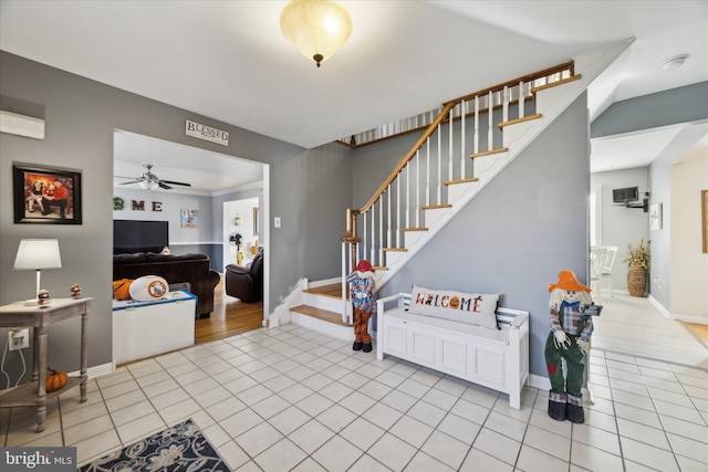 tiled foyer with ceiling fan