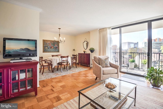 living room featuring light parquet floors, an inviting chandelier, ornamental molding, and a textured ceiling