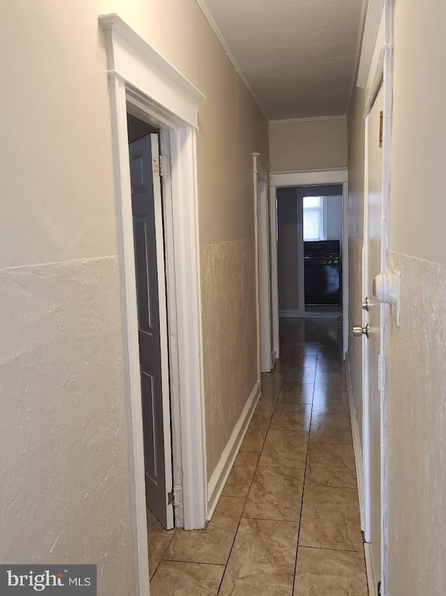 hallway featuring ornamental molding