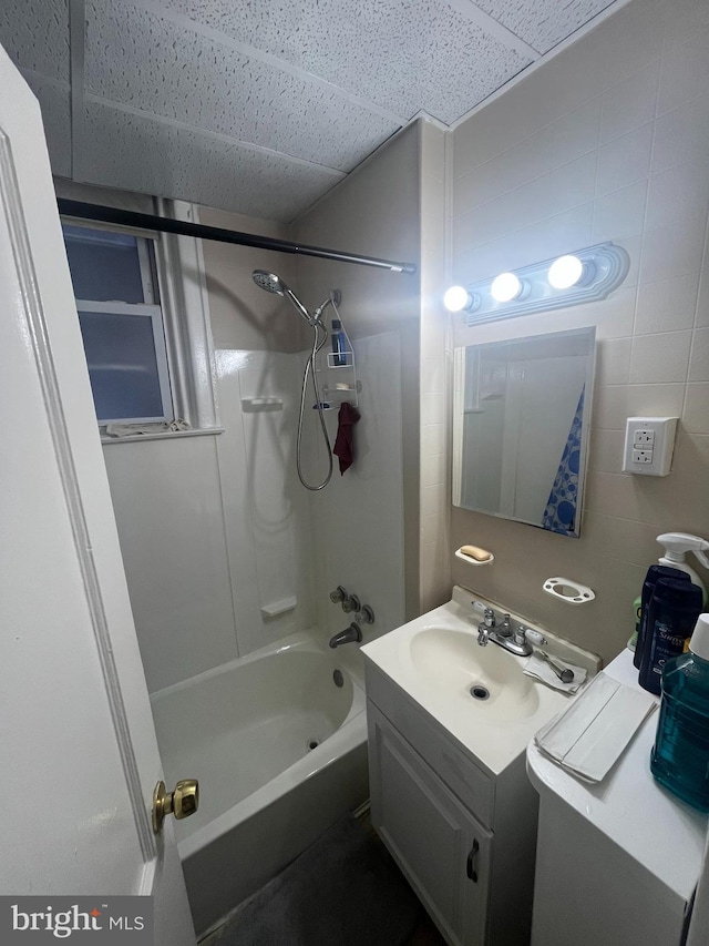 bathroom featuring vanity and  shower combination