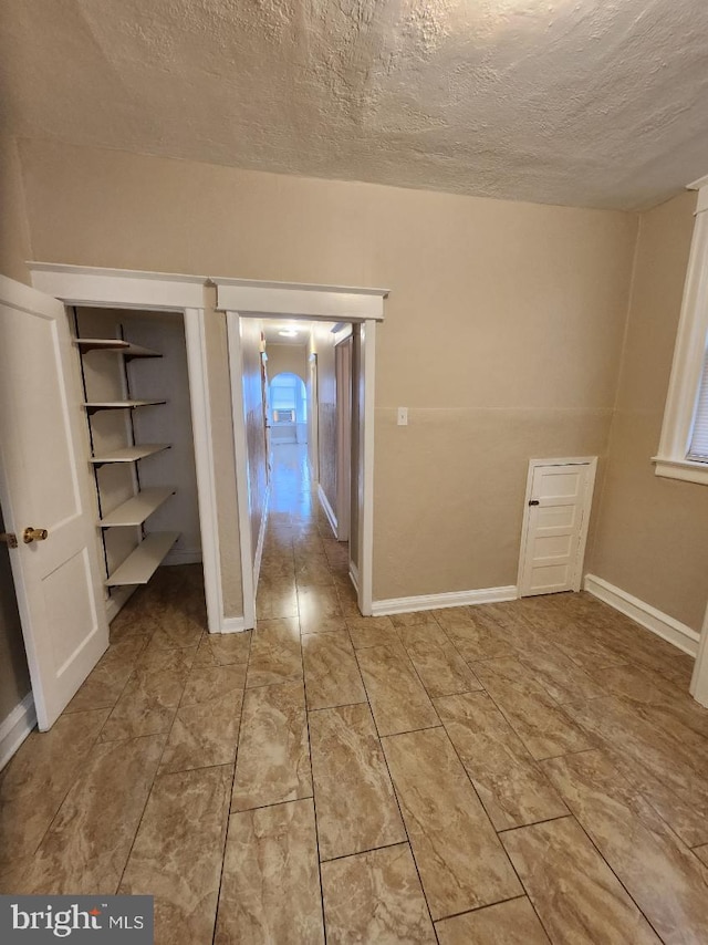 unfurnished bedroom with a textured ceiling