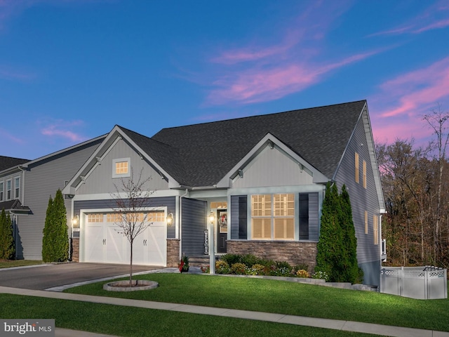 view of front facade with a garage and a lawn