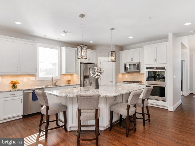 kitchen featuring white cabinetry, appliances with stainless steel finishes, and a center island