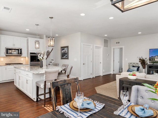 dining space featuring dark hardwood / wood-style flooring