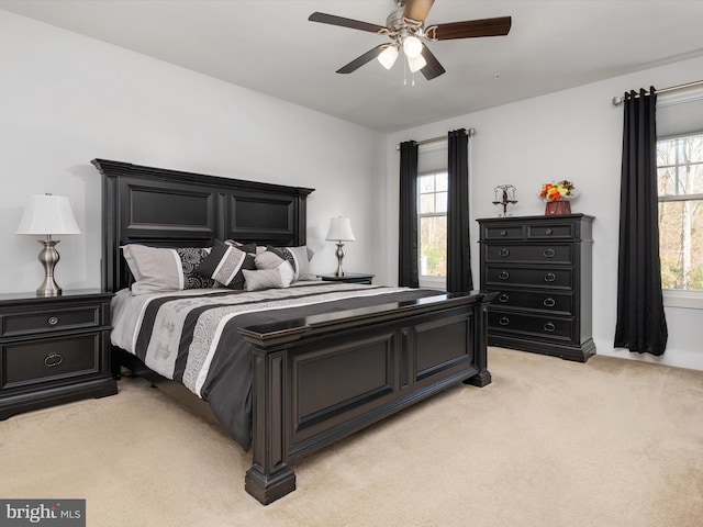 bedroom featuring light colored carpet and ceiling fan