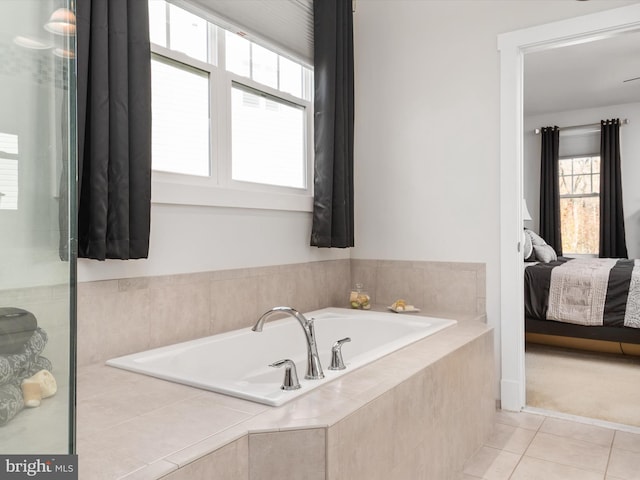 bathroom featuring tiled bath and tile patterned flooring