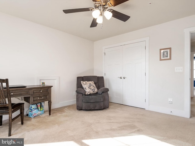 living area with ceiling fan and light carpet