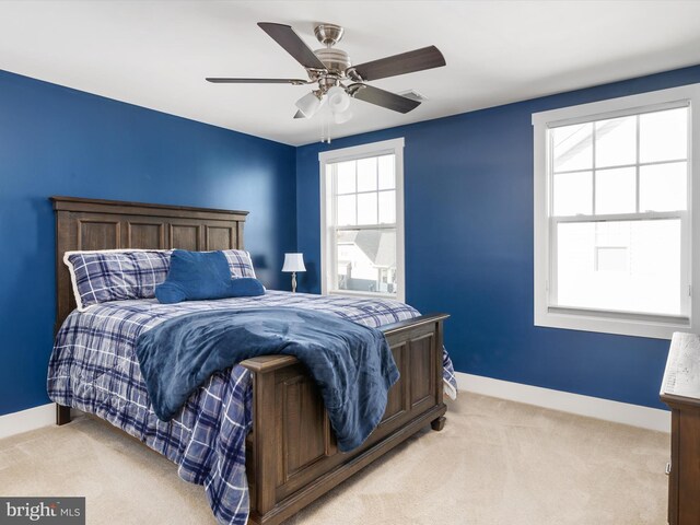 carpeted bedroom featuring ceiling fan