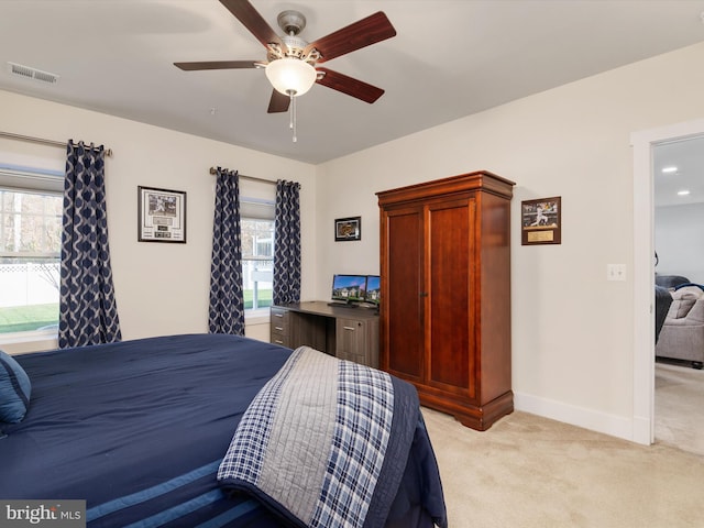 bedroom with light colored carpet and ceiling fan