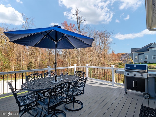 wooden deck featuring a grill